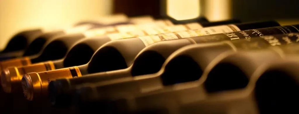 row of red wine bottles in a Burgundy cellar